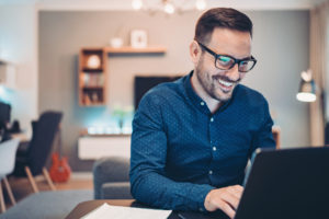 Businessman using laptop to convert PDF at home