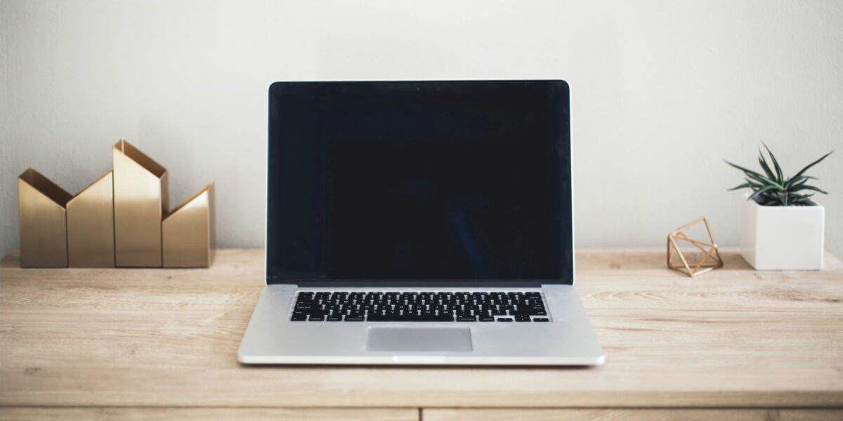 Buying a computer? An image of a new computer sits on a desk in an office space.