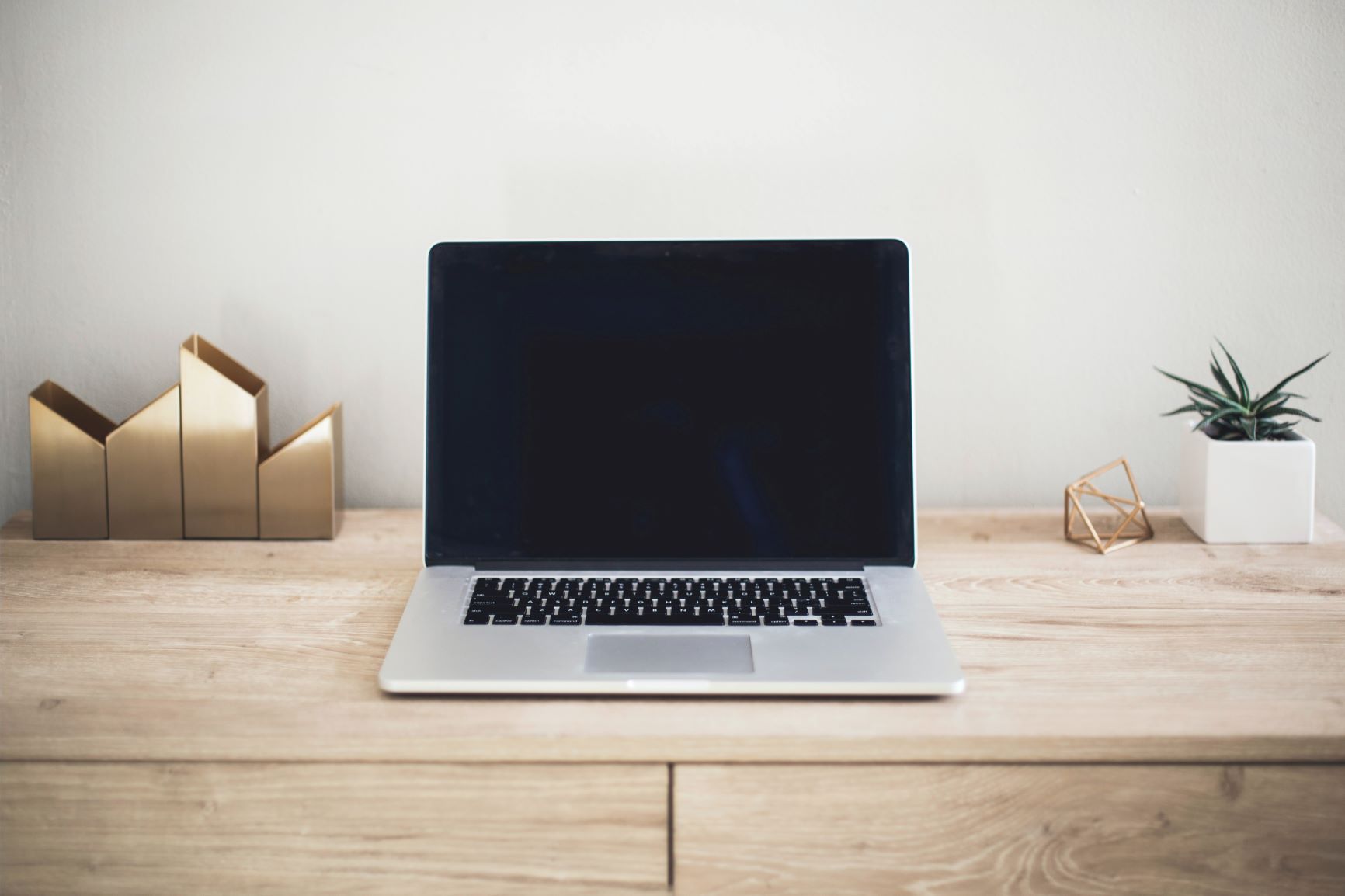 Buying a computer? An image of a new computer sits on a desk in an office space.