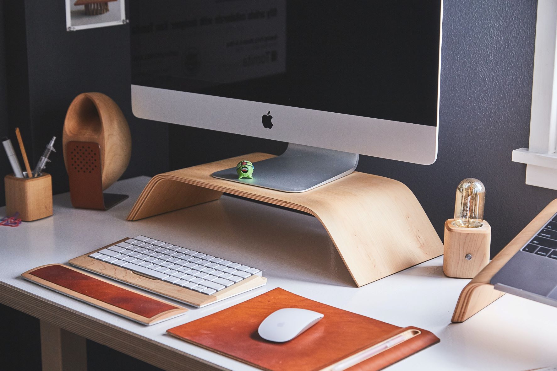 A clean work computer sits on an organized desk with a mouse and keyboard in front of it.