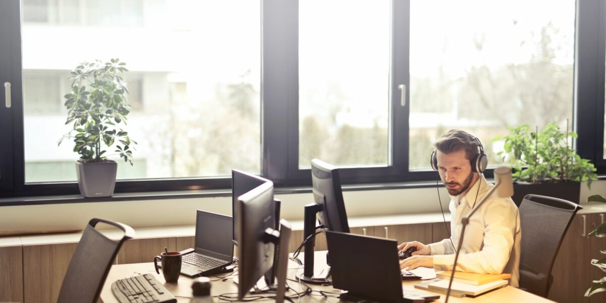 IT support services agent working on office computers to check for updates, spyware, and other computer issues.