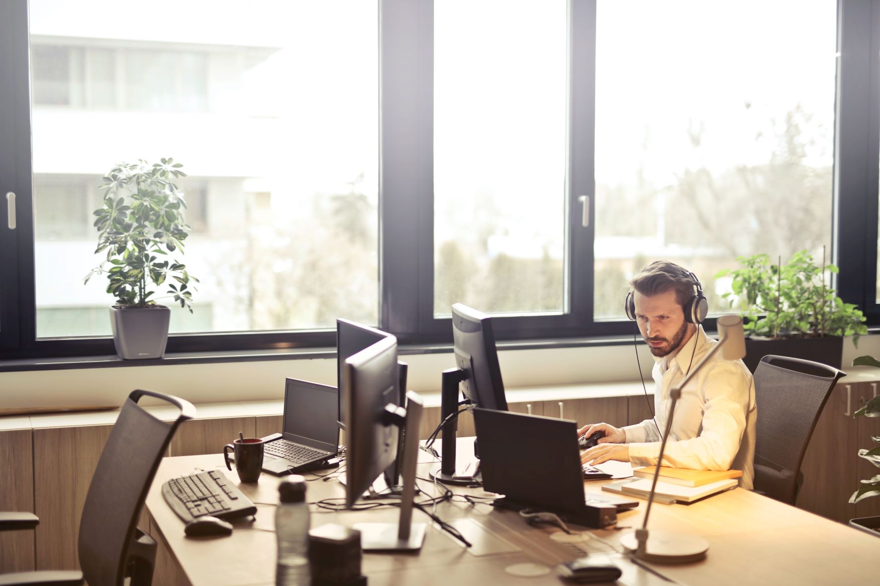 IT support services agent working on office computers to check for updates, spyware, and other computer issues.