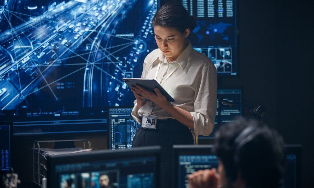 woman on computer tablet helping with managed firewall services for a client