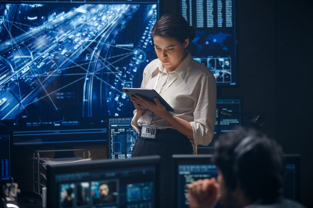 woman on computer tablet helping with managed firewall services for a client