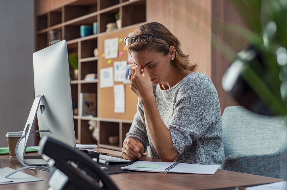 woman sitting at an office desk and working with a computer