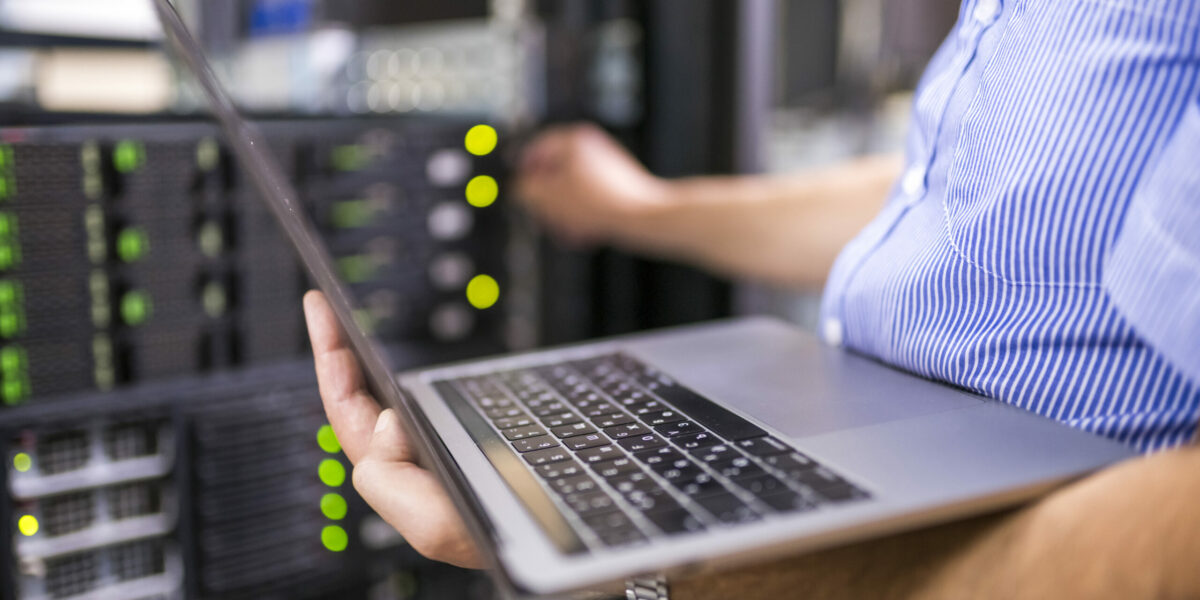 Engineer in the server room working on network security services