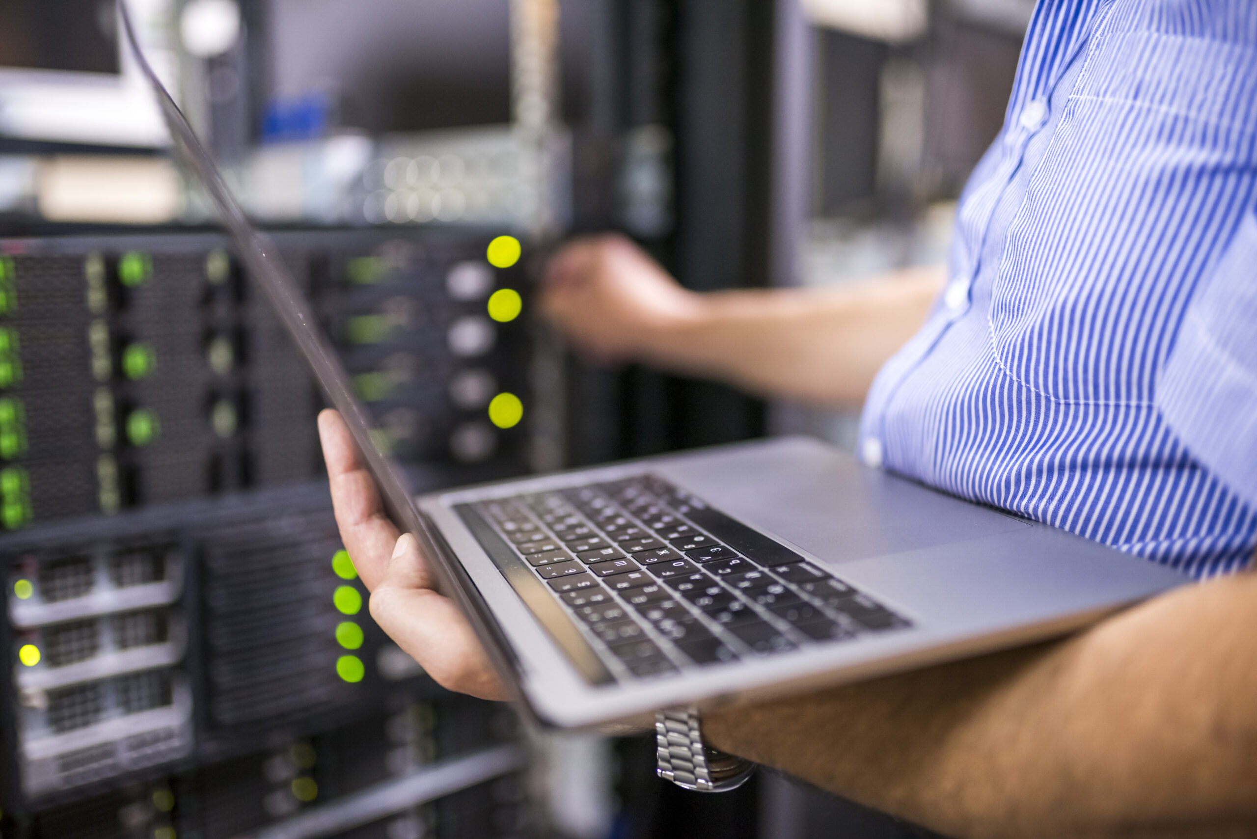 Engineer in the server room working on network security services