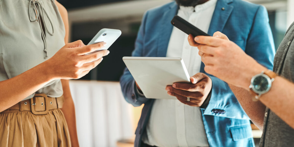 A business group connecting on their devices to their computer networking system.