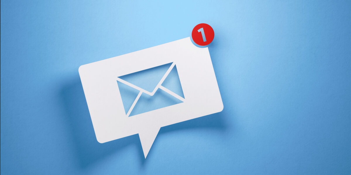 White chat bubble with email symbol on blue background to symbolize email service provided. Horizontal composition with copy space.