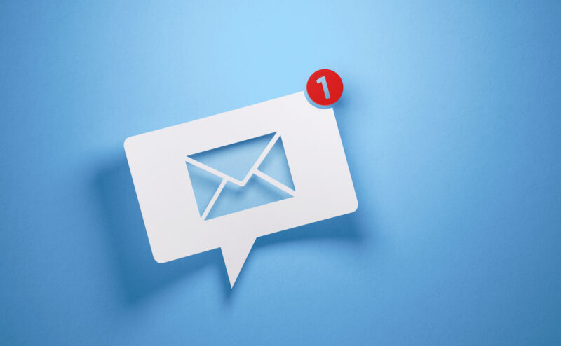 White chat bubble with email symbol on blue background to symbolize email service provided. Horizontal composition with copy space.
